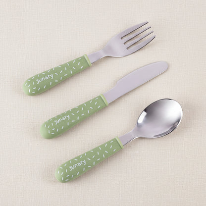 Three-piece baby cutlery set with green handles and silver stainless steel heads, featuring a fork, knife, and spoon on a white background.