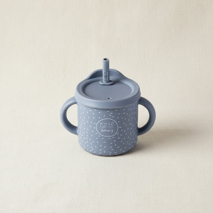 Blue Sips cup with two handles. Removable lid and straw. Stainless-steel and silicone speckles pattern. 