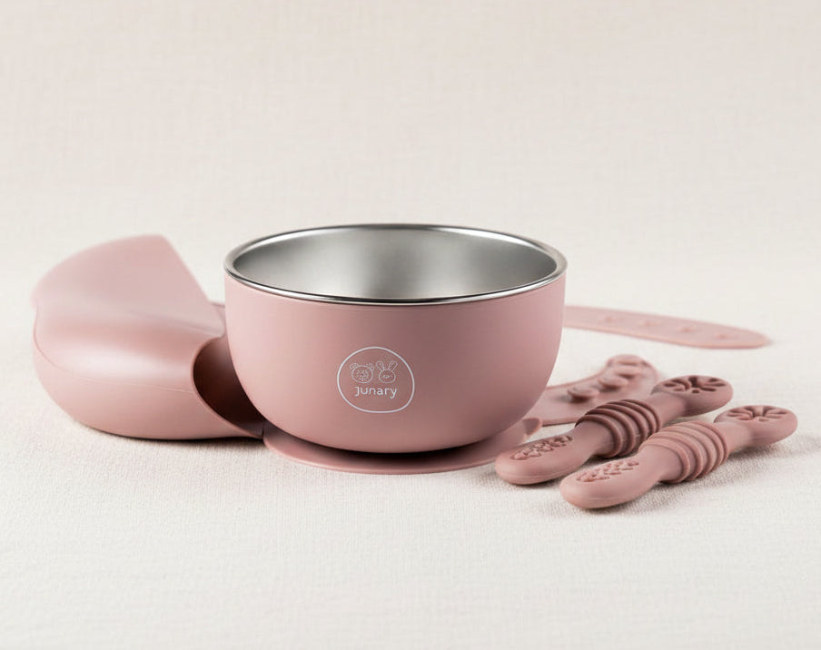 Pink baby feeding set featuring a stainless-steel bowl with silicone suction, and slow feeders.