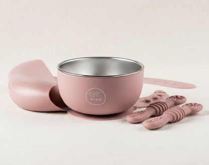 Pink baby feeding set featuring a stainless-steel bowl with silicone suction, and slow feeders.