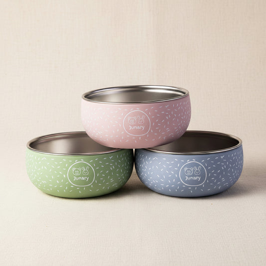 Three silicone and stainless-steel bowls with speckled pattern in pink, green, and blue.