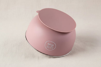 A dusty pink silicone baby feeding bowl with a suction base, shown upside down.