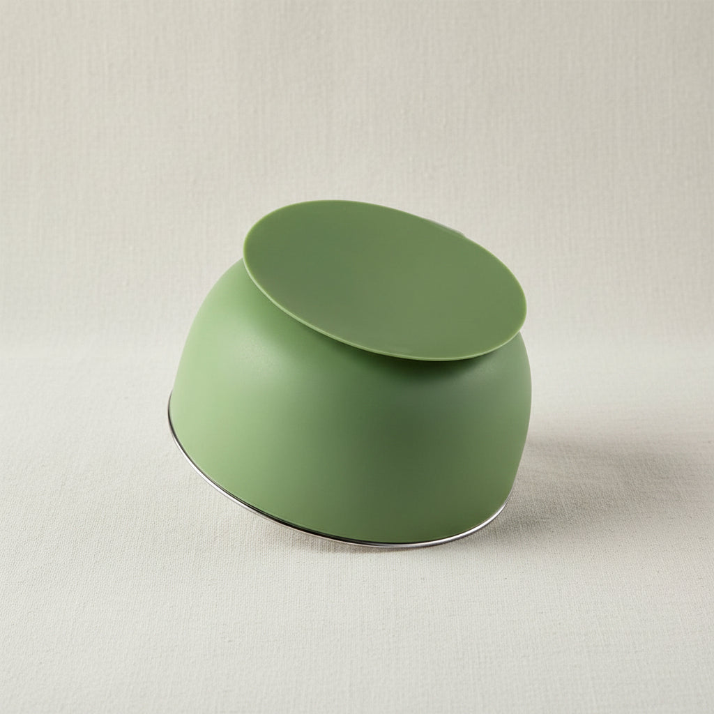 A green Stainless-steel bowl upside down with a green suction base.