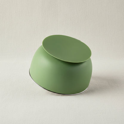 A green Stainless-steel bowl upside down with a green suction base.