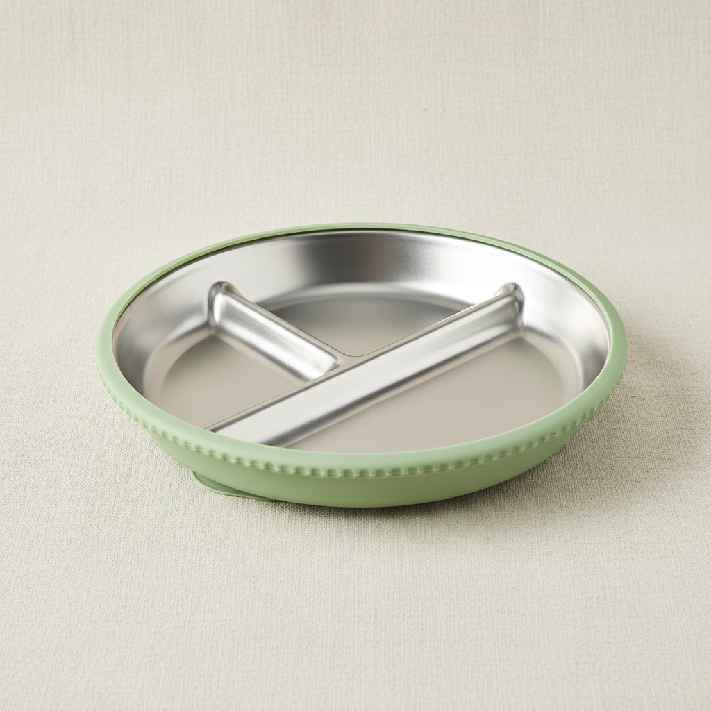 A stainless-steel divided plate with a green silicone and suction base.