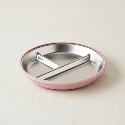 A round divided baby plate with a stainless-steel interior and a pink silicone suction.