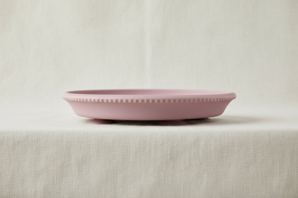 Pink silicone and stainless-steel gripper plate.