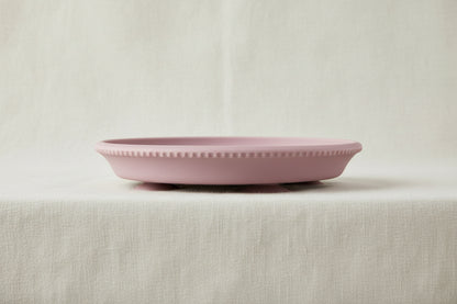 Pink silicone and stainless-steel gripper plate.