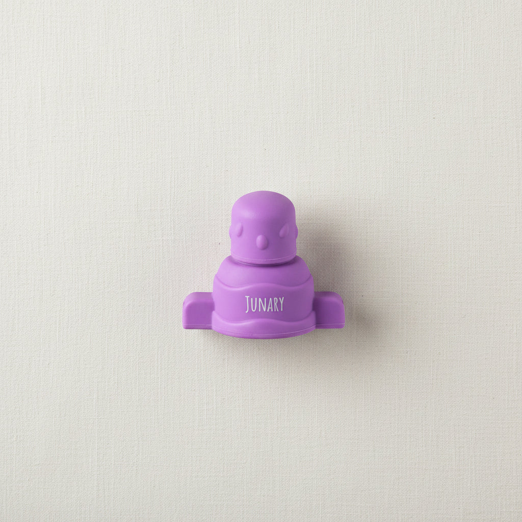 Purple silicone pouch topper for baby squishy pouches. 