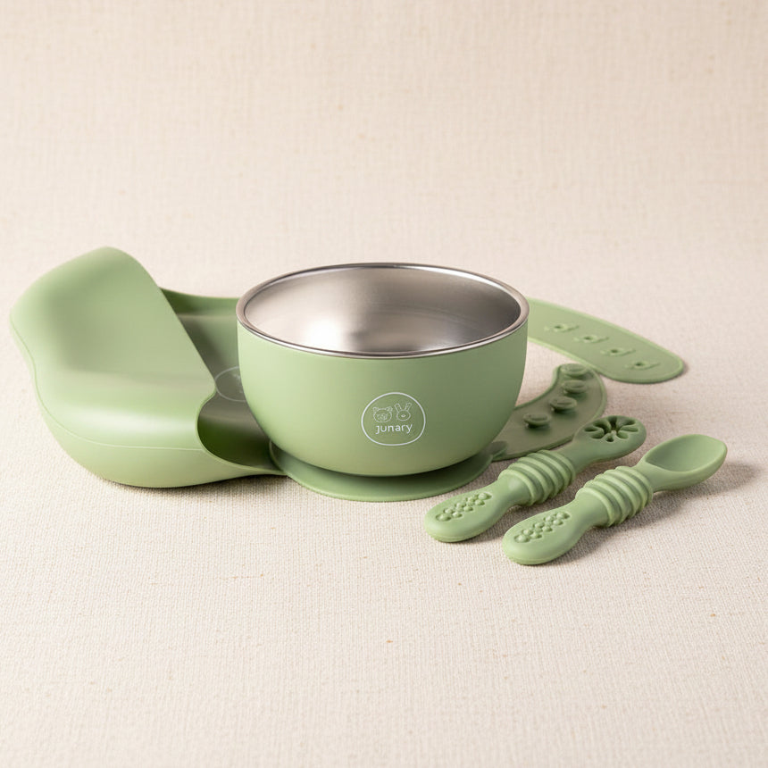 Green 3-piece silicone and stainless-steel set. Including a stainless steel with silicone suction bowl a silicone bucket bib and slow feeder set